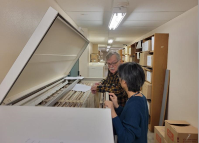 Ronald Grim and Anna Xiong examine the maps.